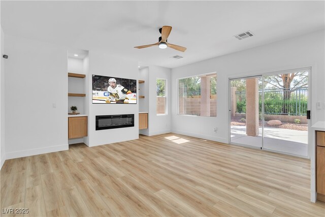 1551 Boundary Peak Way, Las Vegas, NV 89135 - unfurnished living room with light wood finished floors, ceiling fan, a glass covered fireplace, and recessed lighting