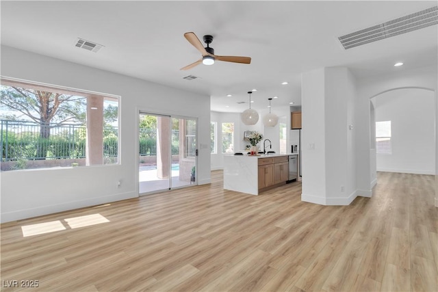 1551 Boundary Peak Way, Las Vegas, NV 89135 - unfurnished living room with arched walkways, recessed lighting, light wood-style flooring, and ceiling fan