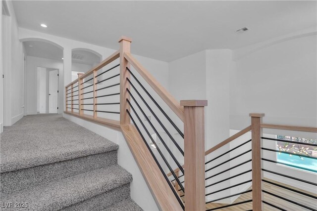 1551 Boundary Peak Way, Las Vegas, NV 89135 - staircase featuring recessed lighting, arched walkways, and carpet