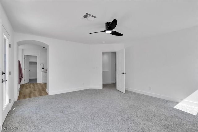 1551 Boundary Peak Way, Las Vegas, NV 89135 - carpeted empty room with arched walkways and ceiling fan