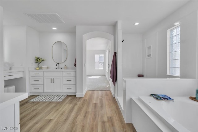 1551 Boundary Peak Way, Las Vegas, NV 89135 - bathroom with vanity, a bath, wood finished floors, and recessed lighting
