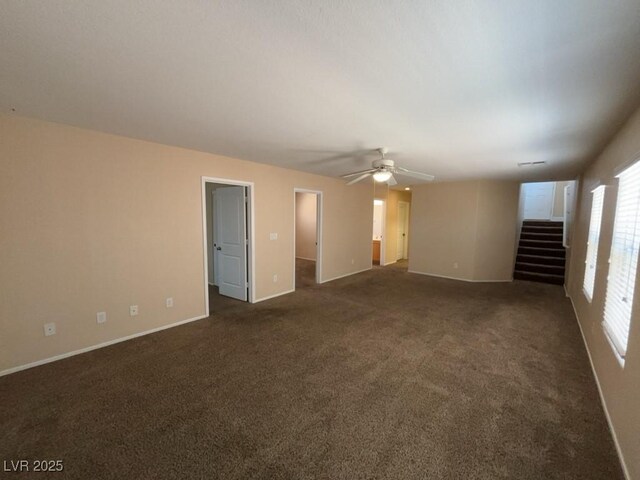 5316 Fireside Ranch Ave, Las Vegas, NV 89131 - spare room featuring a ceiling fan, stairs, and dark carpet