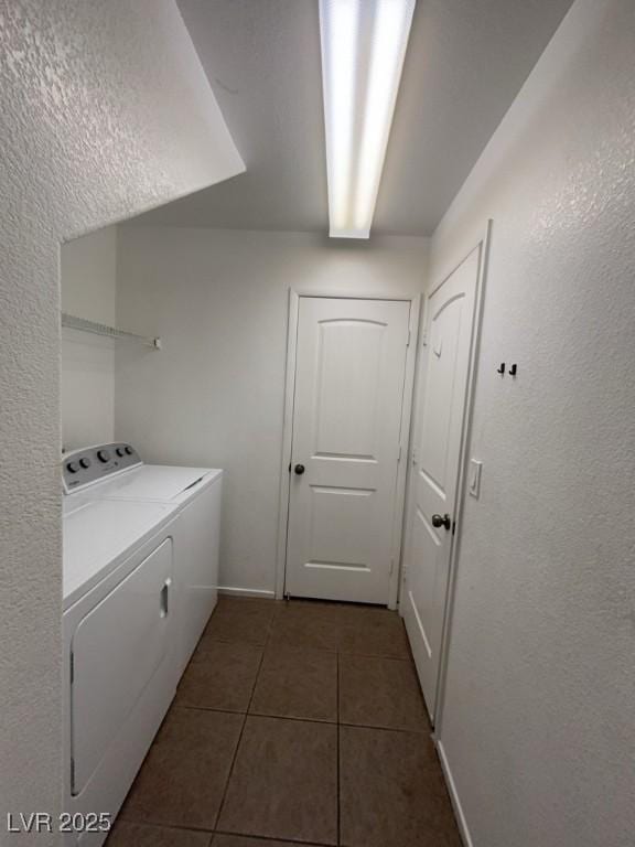 5316 Fireside Ranch Ave, Las Vegas, NV 89131 - laundry room featuring separate washer and dryer, dark tile patterned floors, and a textured wall