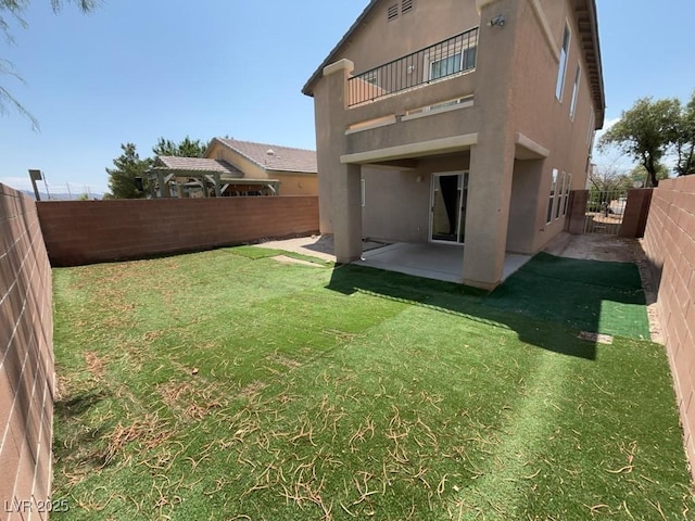 5316 Fireside Ranch Ave, Las Vegas, NV 89131 - rear view of house featuring a balcony, a fenced backyard, stucco siding, and a patio area