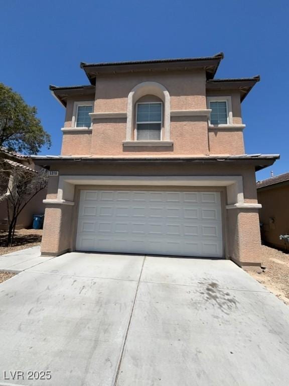 5316 Fireside Ranch Ave, Las Vegas, NV 89131 - view of front of property with an attached garage, stucco siding, and driveway