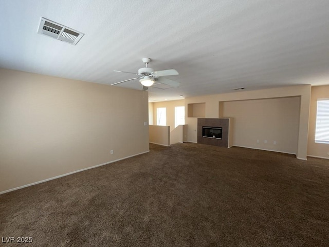 5316 Fireside Ranch Ave, Las Vegas, NV 89131 - unfurnished living room with carpet flooring, a tiled fireplace, and ceiling fan