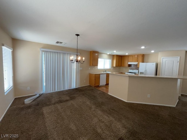 5316 Fireside Ranch Ave, Las Vegas, NV 89131 - kitchen featuring white appliances, a chandelier, light countertops, carpet floors, and recessed lighting