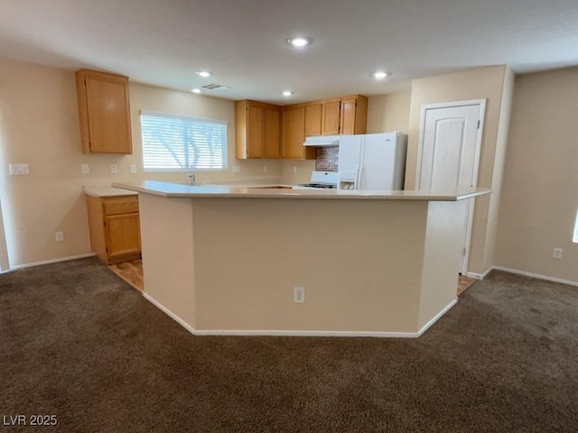 5316 Fireside Ranch Ave, Las Vegas, NV 89131 - kitchen featuring white refrigerator with ice dispenser, dark carpet, stove, under cabinet range hood, and recessed lighting