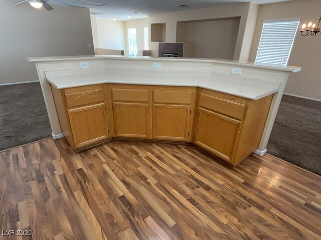 5316 Fireside Ranch Ave, Las Vegas, NV 89131 - kitchen featuring light countertops, open floor plan, dark colored carpet, dark wood-style flooring, and a chandelier