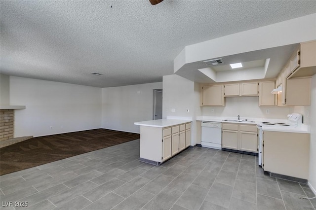 1013 Falconhead Ln Unit 202, Las Vegas, NV 89128 - kitchen featuring white appliances, a peninsula, a textured ceiling, open floor plan, and light countertops