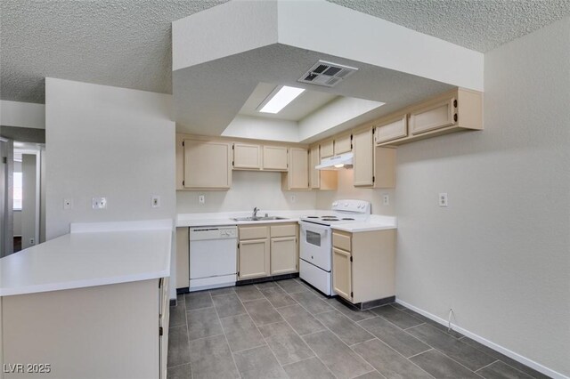 1013 Falconhead Ln Unit 202, Las Vegas, NV 89128 - kitchen featuring white appliances, under cabinet range hood, a peninsula, a textured ceiling, and light countertops