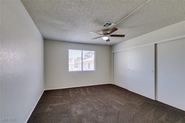 1013 Falconhead Ln Unit 202, Las Vegas, NV 89128 - unfurnished bedroom with carpet, a closet, a ceiling fan, and a textured ceiling