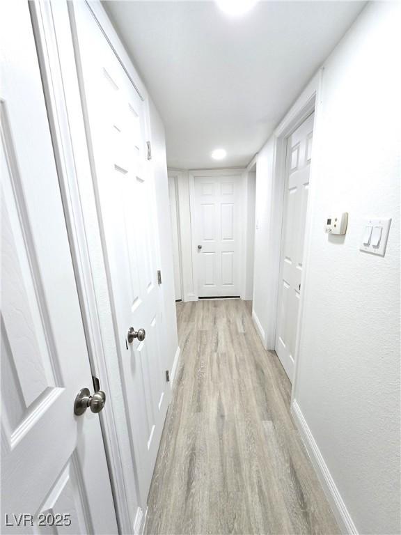 4324 El Conlon Ave, Las Vegas, NV 89102 - hallway featuring light wood-type flooring and baseboards