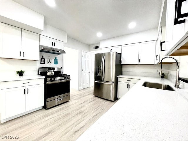 4324 El Conlon Ave, Las Vegas, NV 89102 - kitchen featuring stainless steel appliances, under cabinet range hood, white cabinetry, recessed lighting, and light wood-type flooring