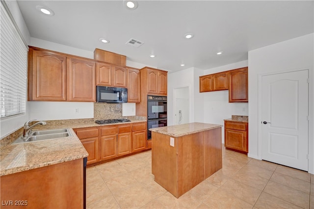 2261 Dalton Ridge Ct, North Las Vegas, NV 89031 - kitchen featuring black appliances, light tile patterned floors, a center island, light stone counters, and backsplash