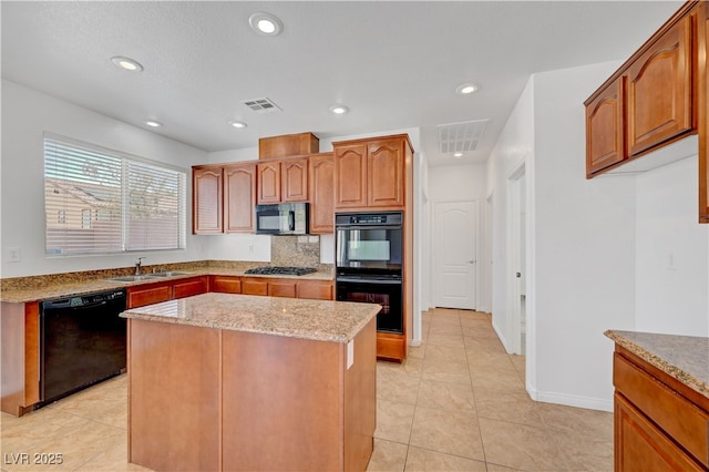 2261 Dalton Ridge Ct, North Las Vegas, NV 89031 - kitchen featuring black appliances, light stone countertops, a center island, light tile patterned flooring, and recessed lighting