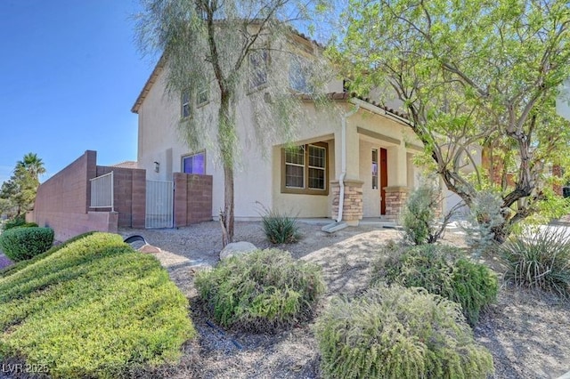2261 Dalton Ridge Ct, North Las Vegas, NV 89031 - view of front of property with stucco siding, a gate, and stone siding
