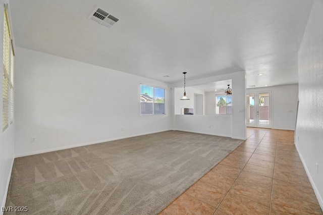 2261 Dalton Ridge Ct, North Las Vegas, NV 89031 - unfurnished living room featuring light tile patterned flooring, a ceiling fan, and light carpet