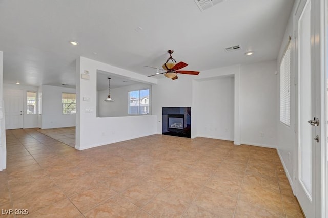 2261 Dalton Ridge Ct, North Las Vegas, NV 89031 - unfurnished living room with a ceiling fan, plenty of natural light, a fireplace, recessed lighting, and light tile patterned floors