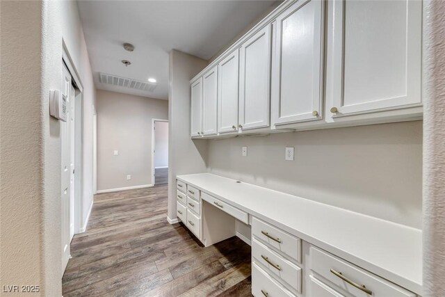 7606 Kenwood Hills Ct, Las Vegas, NV 89131 - unfurnished office featuring built in study area, dark wood-style flooring, and recessed lighting