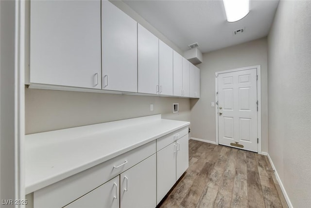 7606 Kenwood Hills Ct, Las Vegas, NV 89131 - laundry room with cabinet space, light wood finished floors, and hookup for a washing machine