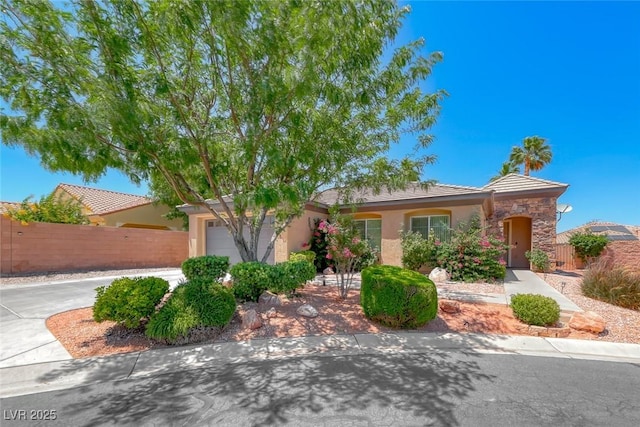 7606 Kenwood Hills Ct, Las Vegas, NV 89131 - view of front facade featuring an attached garage, stucco siding, stone siding, and a tiled roof