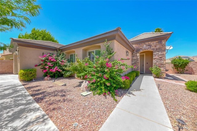 7606 Kenwood Hills Ct, Las Vegas, NV 89131 - view of front of property with stone siding, stucco siding, and a tiled roof