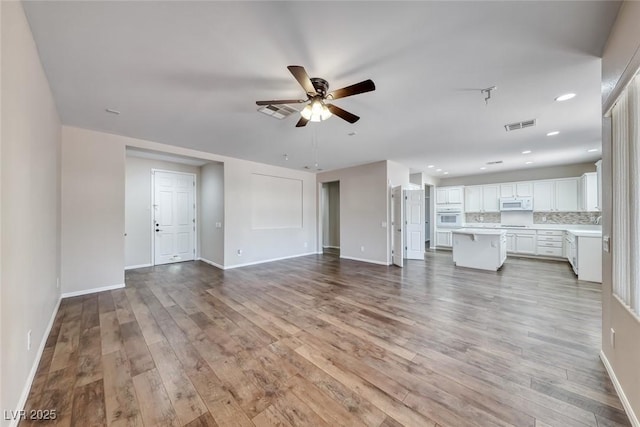 7606 Kenwood Hills Ct, Las Vegas, NV 89131 - unfurnished living room featuring a ceiling fan, wood finished floors, and recessed lighting