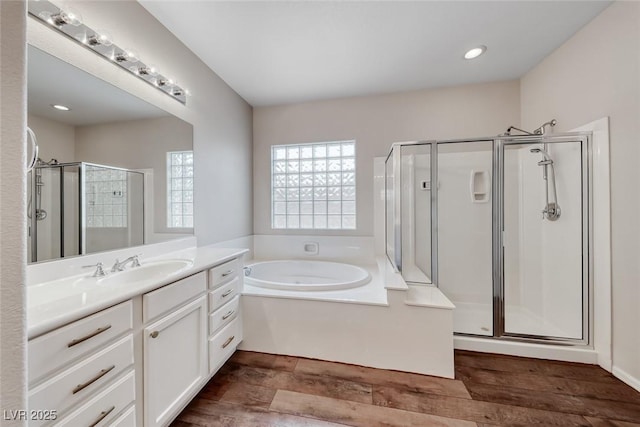 7606 Kenwood Hills Ct, Las Vegas, NV 89131 - full bath featuring vanity, a shower stall, a bath, wood finished floors, and recessed lighting