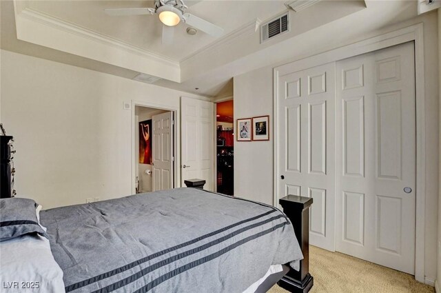 2405 W Serene Ave Unit 612, Las Vegas, NV 89123 - bedroom featuring light colored carpet, crown molding, a tray ceiling, a closet, and ceiling fan