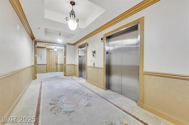 2405 W Serene Ave Unit 612, Las Vegas, NV 89123 - hallway featuring elevator, carpet, wainscoting, ornamental molding, and a raised ceiling