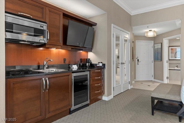 135 E Harmon Ave Unit 3816, Las Vegas, NV 89109 - kitchen with stainless steel microwave, wine cooler, dark countertops, ornamental molding, and brown cabinets