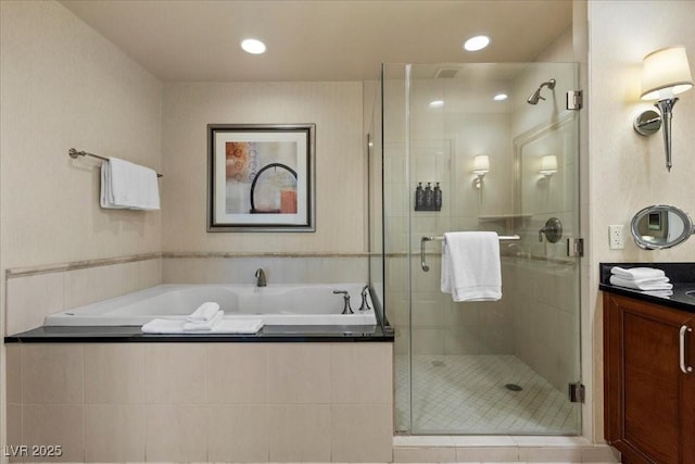 135 E Harmon Ave Unit 3816, Las Vegas, NV 89109 - bathroom featuring a garden tub, vanity, a stall shower, and recessed lighting