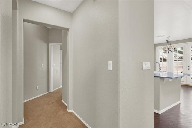 8612 Chiquita Dr, Las Vegas, NV 89128 - hallway with baseboards and a chandelier