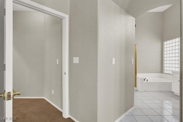 8612 Chiquita Dr, Las Vegas, NV 89128 - hallway featuring baseboards and light tile patterned floors