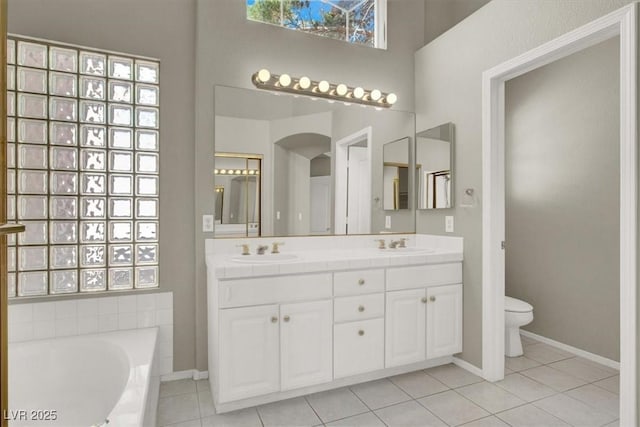 8612 Chiquita Dr, Las Vegas, NV 89128 - full bathroom featuring tile patterned floors, double vanity, a bath, and a high ceiling