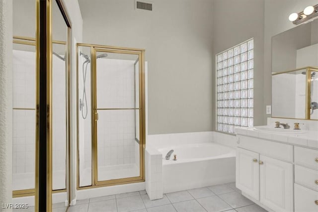 8612 Chiquita Dr, Las Vegas, NV 89128 - full bath featuring vanity, a stall shower, a garden tub, and tile patterned floors