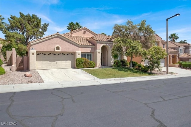 8612 Chiquita Dr, Las Vegas, NV 89128 - mediterranean / spanish home with stucco siding, a garage, driveway, a tiled roof, and a gate