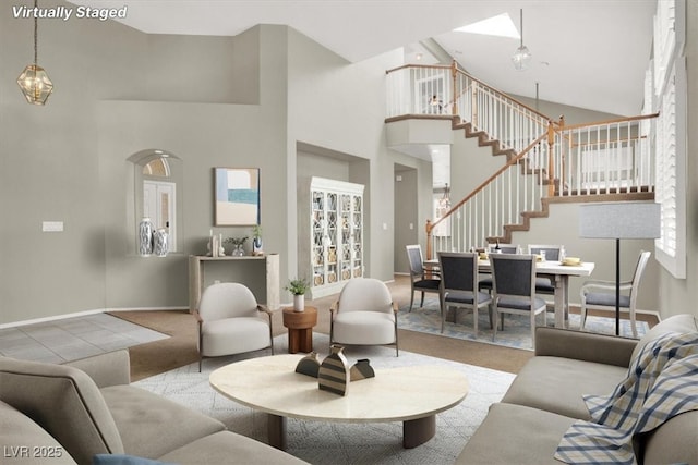 8612 Chiquita Dr, Las Vegas, NV 89128 - carpeted living room featuring a high ceiling, stairway, and a chandelier