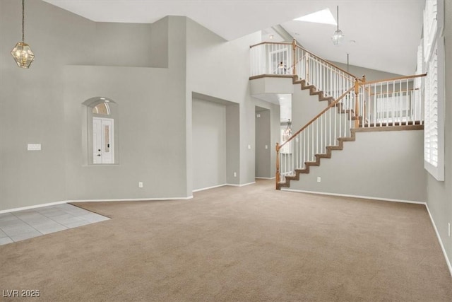 8612 Chiquita Dr, Las Vegas, NV 89128 - unfurnished living room with carpet, a high ceiling, stairway, and a chandelier