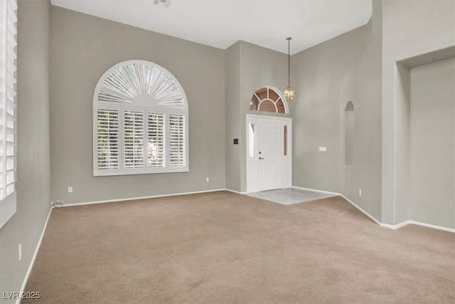 8612 Chiquita Dr, Las Vegas, NV 89128 - foyer entrance with carpet, plenty of natural light, and a towering ceiling