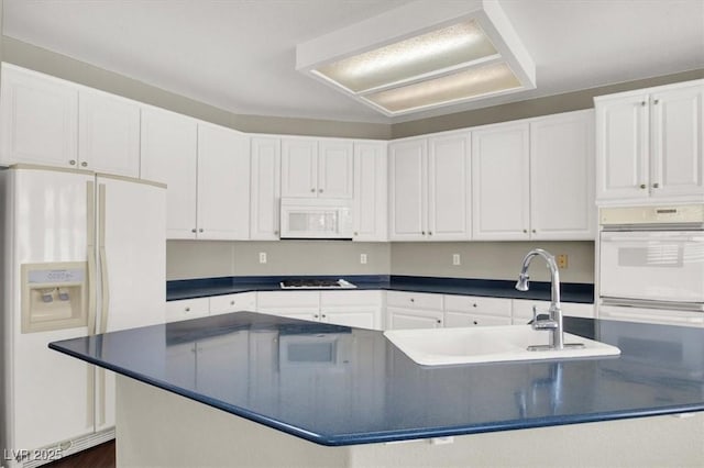 8612 Chiquita Dr, Las Vegas, NV 89128 - kitchen featuring white appliances, dark countertops, and white cabinetry