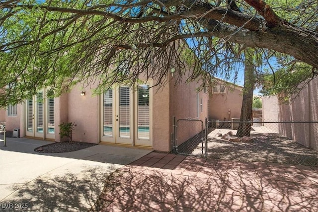 8612 Chiquita Dr, Las Vegas, NV 89128 - view of home's exterior with french doors, stucco siding, a patio area, and a gate