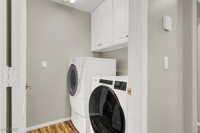 8612 Chiquita Dr, Las Vegas, NV 89128 - laundry area with washing machine and dryer, cabinet space, and light wood-style floors