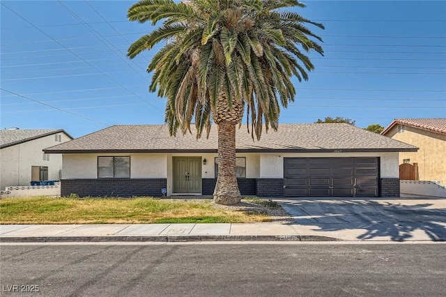 3047 Van Buskirk Cir, Las Vegas, NV 89121 - view of front of property featuring stucco siding, a garage, brick siding, and concrete driveway