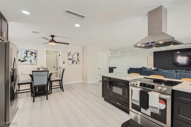 3047 Van Buskirk Cir, Las Vegas, NV 89121 - kitchen featuring appliances with stainless steel finishes, island range hood, light wood finished floors, open floor plan, and ceiling fan