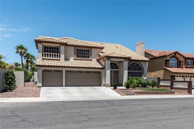 8820 Fall Green Ave, Las Vegas, NV 89129 - mediterranean / spanish-style house with stucco siding, a garage, concrete driveway, a tiled roof, and a gate