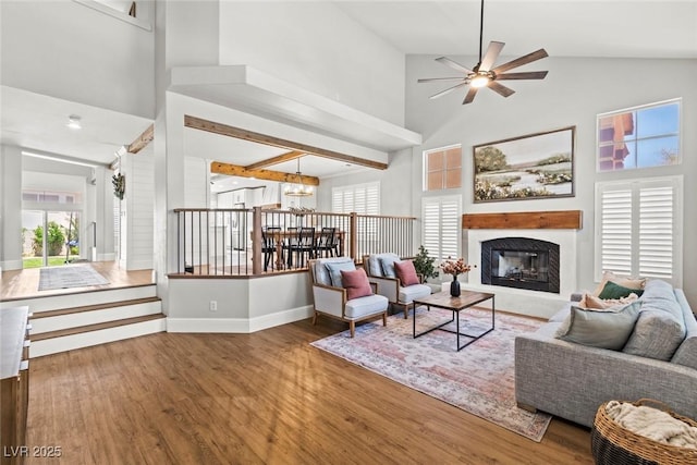 8820 Fall Green Ave, Las Vegas, NV 89129 - living room featuring high vaulted ceiling, a glass covered fireplace, healthy amount of natural light, and wood finished floors