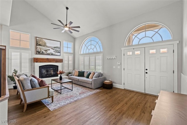 8820 Fall Green Ave, Las Vegas, NV 89129 - living area with high vaulted ceiling, ceiling fan, wood finished floors, and a glass covered fireplace