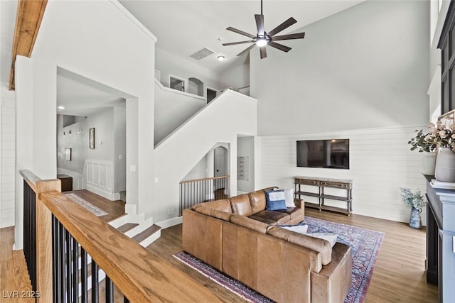 8820 Fall Green Ave, Las Vegas, NV 89129 - living area featuring ceiling fan, wood finished floors, high vaulted ceiling, and stairs